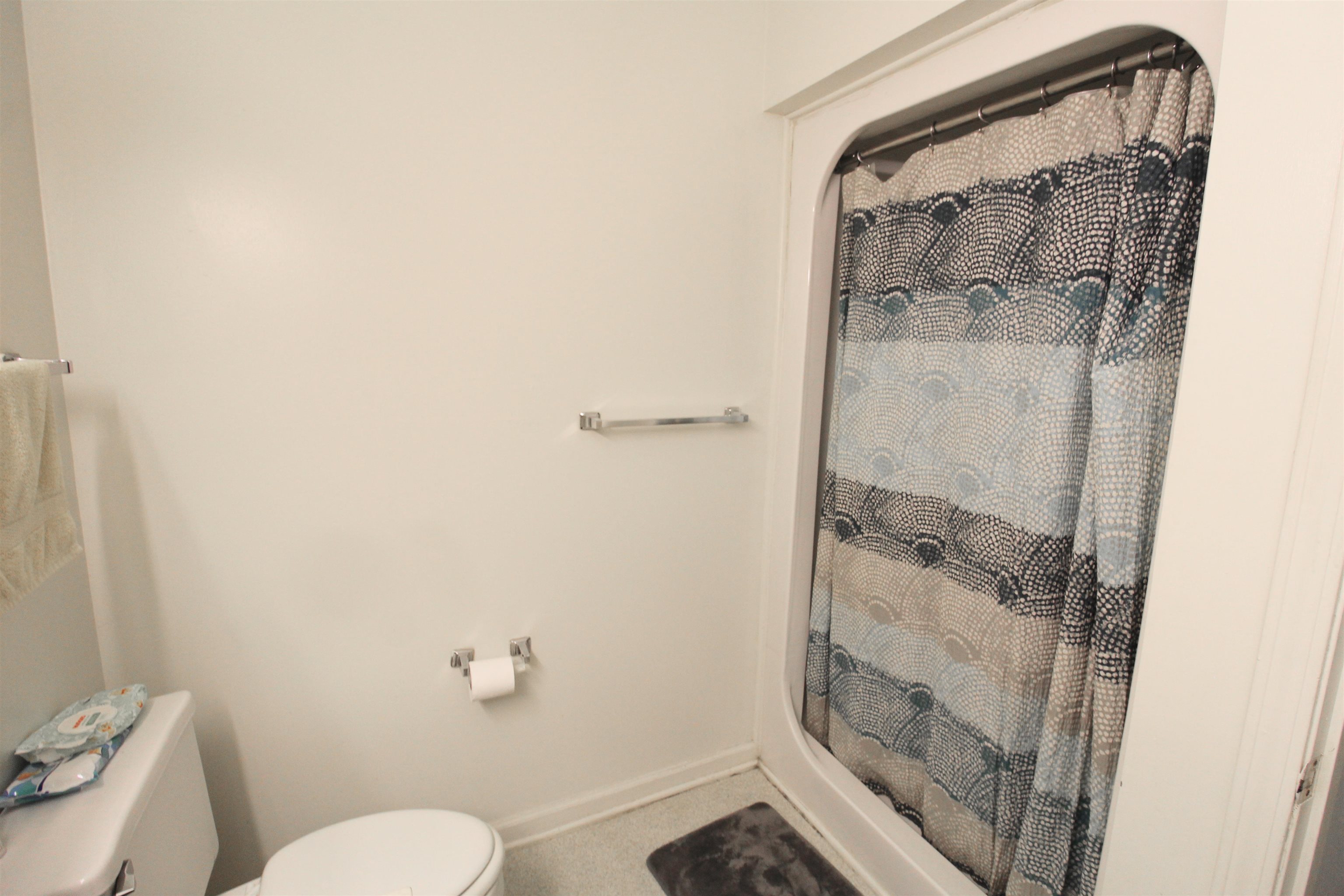 1116 Blue Ridge Drive, Unit 10 Harrisonburg, VA 22802 - Photo 18 of 20 a bathroom with a granite countertop shower and a toilet