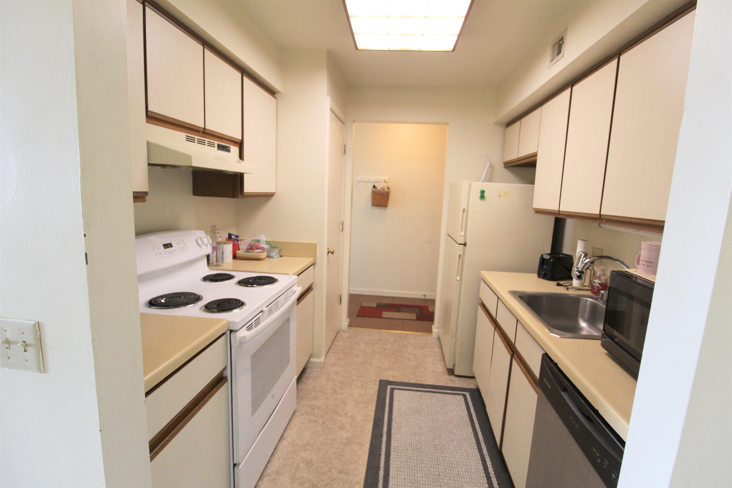 1116 Blue Ridge Drive, Unit 10 Harrisonburg, VA 22802 - Photo 8 of 20 a kitchen with stainless steel appliances granite countertop a sink stove and refrigerator