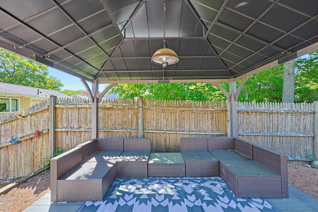 118 Spruce Road Norwood, MA 02062 - Photo 32 of 39 a view of a patio with table and chairs with wooden fence