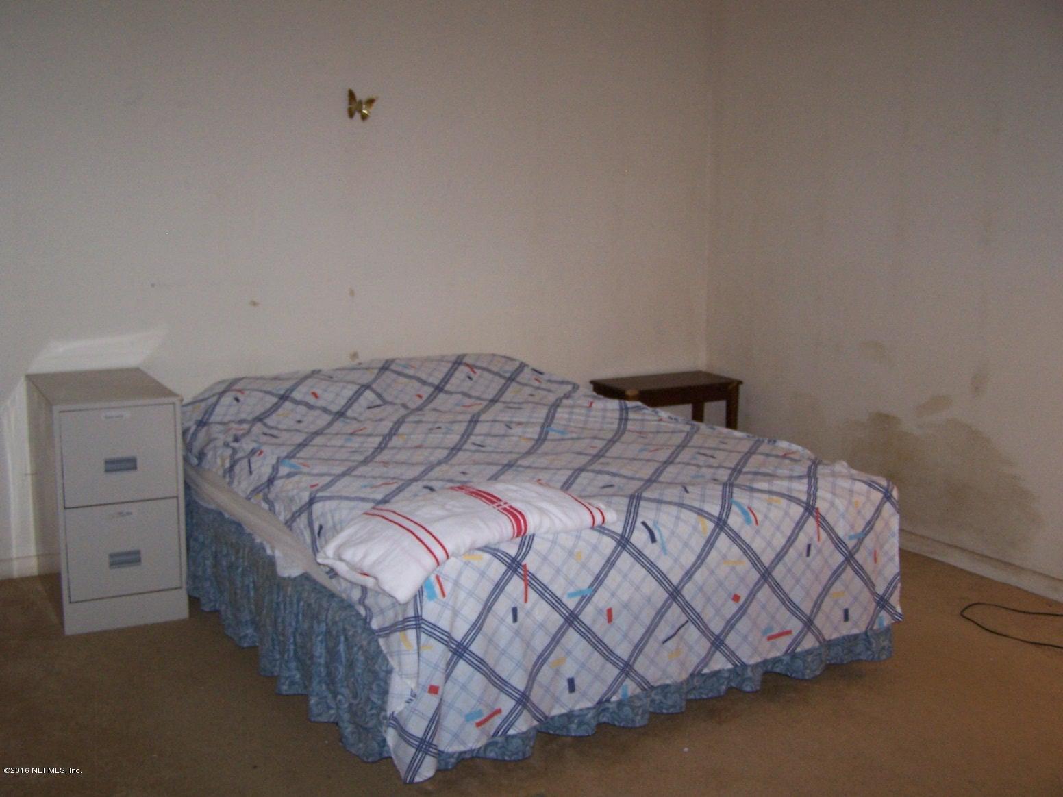 4190 Pine Road Orange Park, FL 32065 - Photo 11 of 11 a bedroom with a bed and a night stand