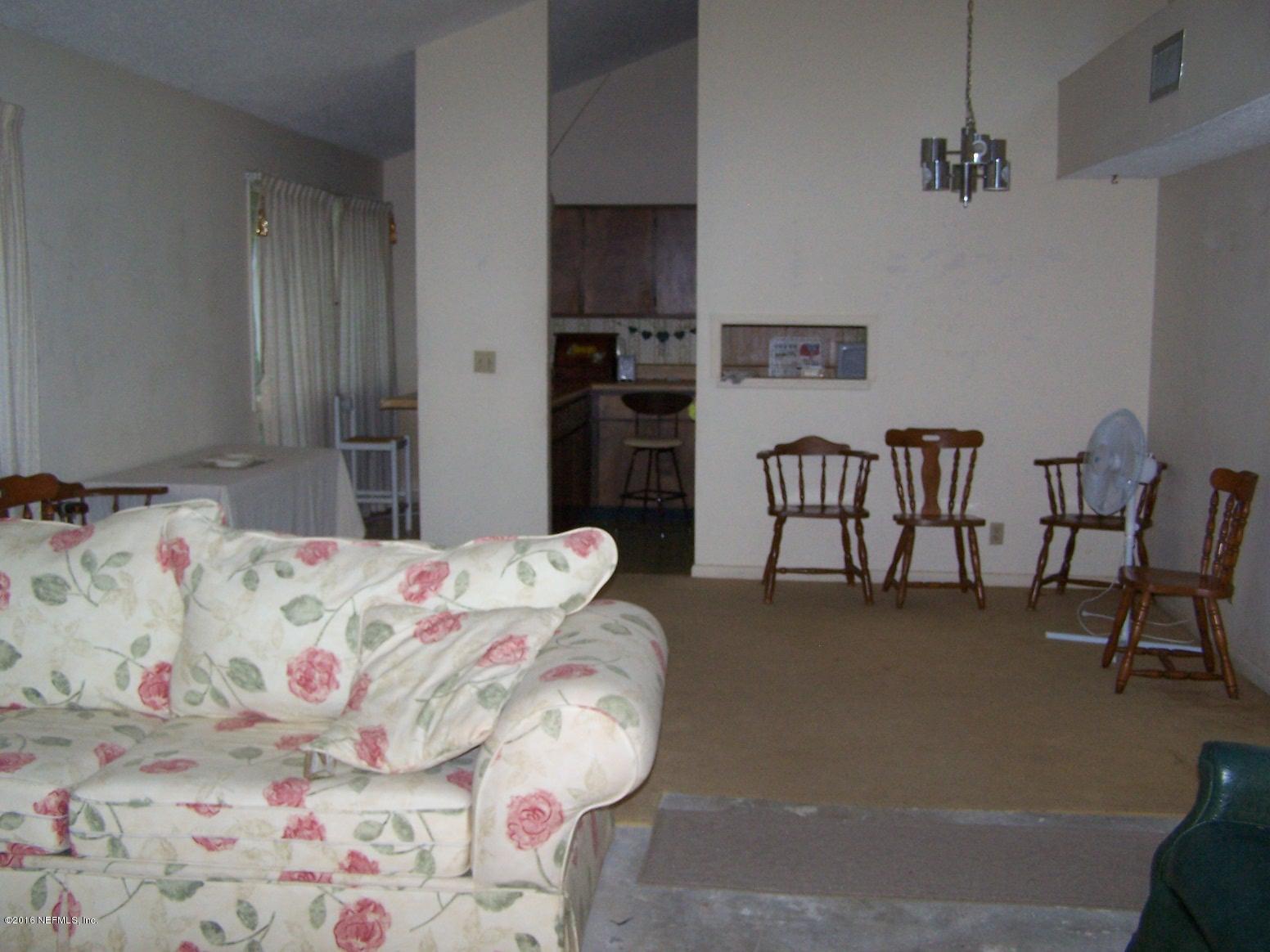 4190 Pine Road Orange Park, FL 32065 - Photo 3 of 11 a bedroom with a bed and a chair in it