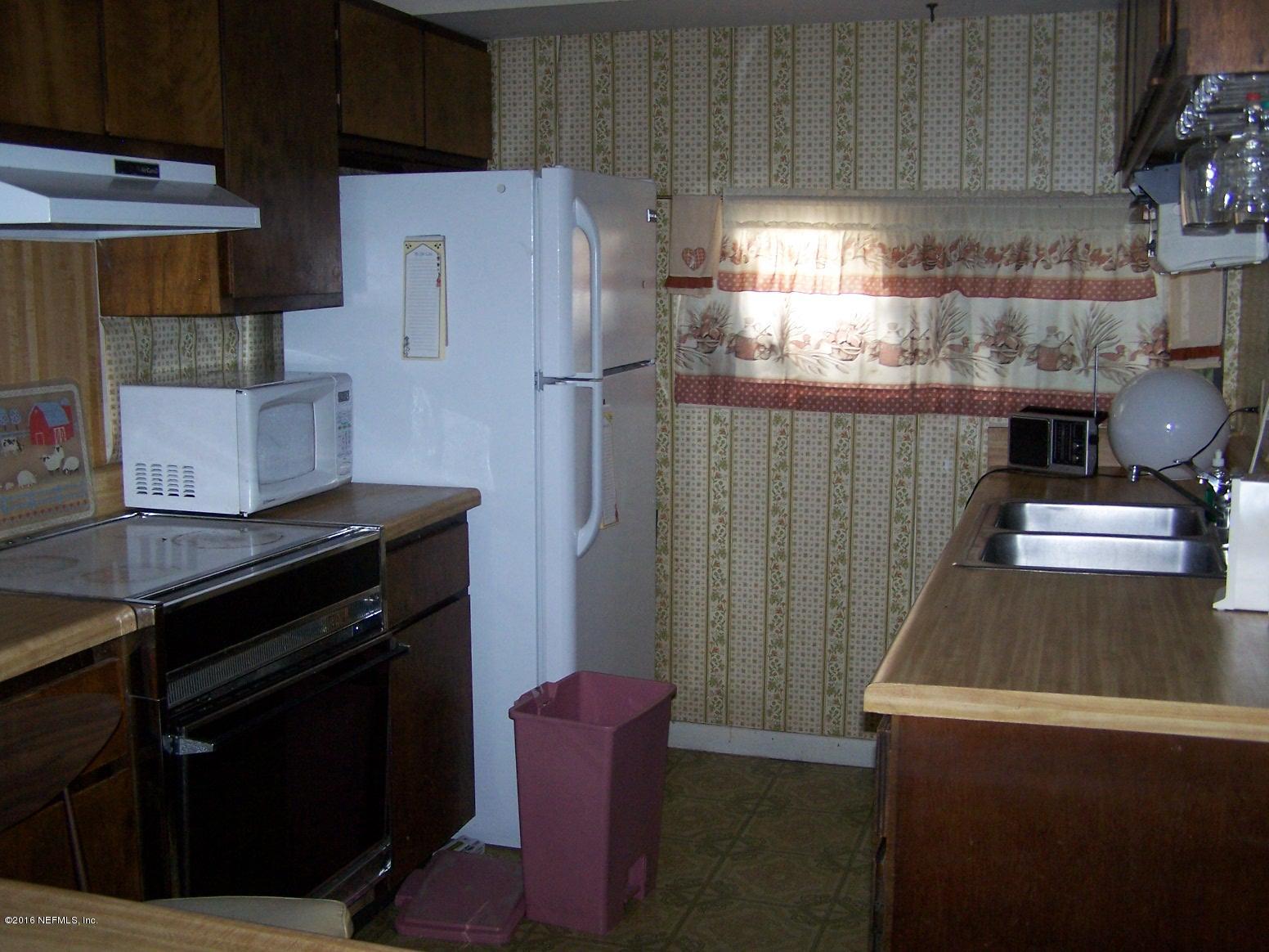 4190 Pine Road Orange Park, FL 32065 - Photo 4 of 11 a kitchen with stainless steel appliances a stove a refrigerator and a cabinets