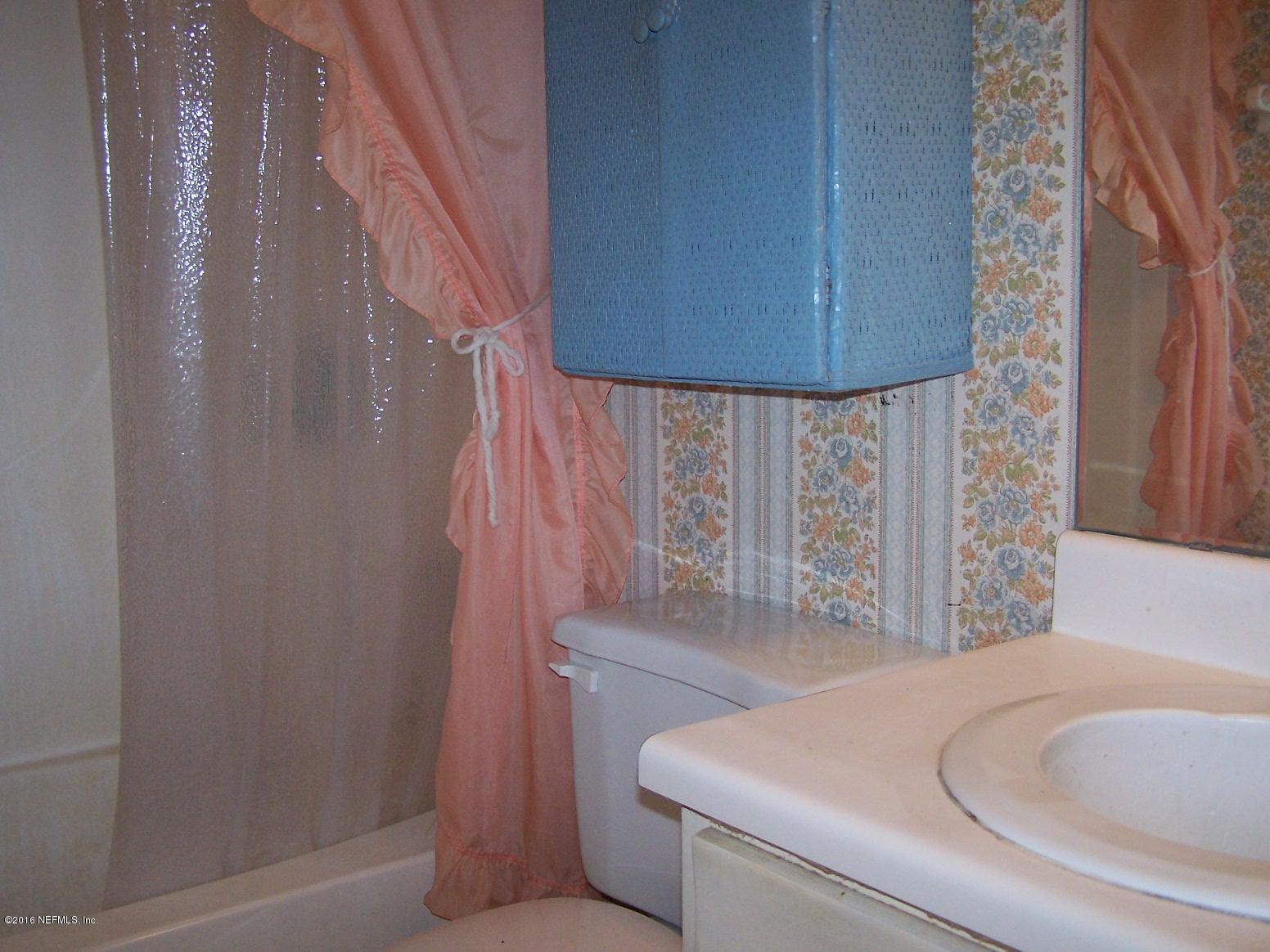 4190 Pine Road Orange Park, FL 32065 - Photo 10 of 11 a bathroom with a bathtub and shower