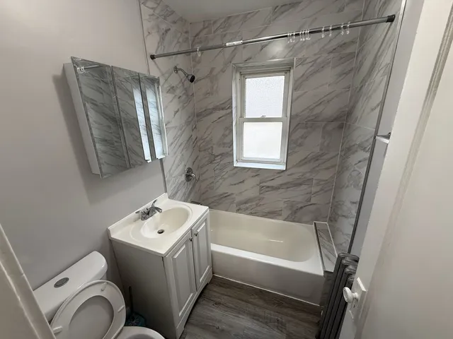 a bathroom with a sink toilet and shower