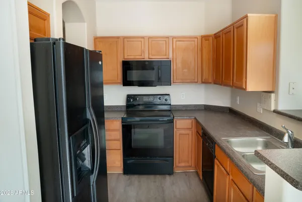 a kitchen with a refrigerator and a sink