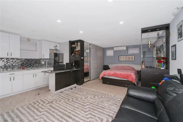 a bedroom with a bed and dresser