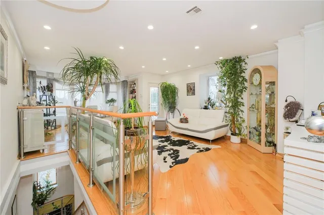 a living room with furniture and potted plants