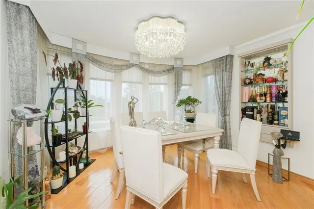 a view of a dining room with furniture and chandelier