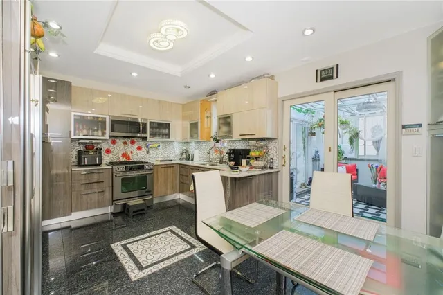 a kitchen with a refrigerator and a stove top oven