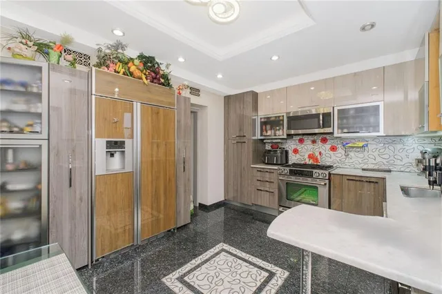 a kitchen with a refrigerator and a stove top oven