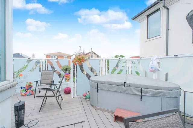 a view of roof deck with dining table and chairs