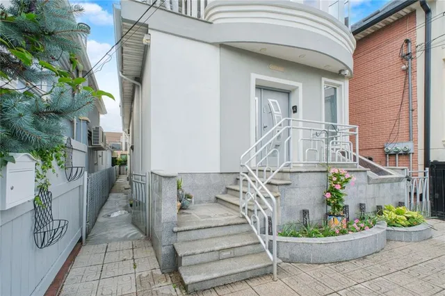 a view of a house with a potted plant and a bench