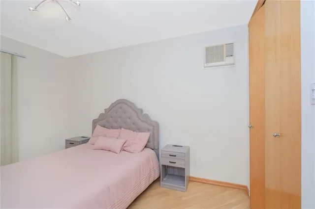 a large bed sitting in a bedroom next to a wall