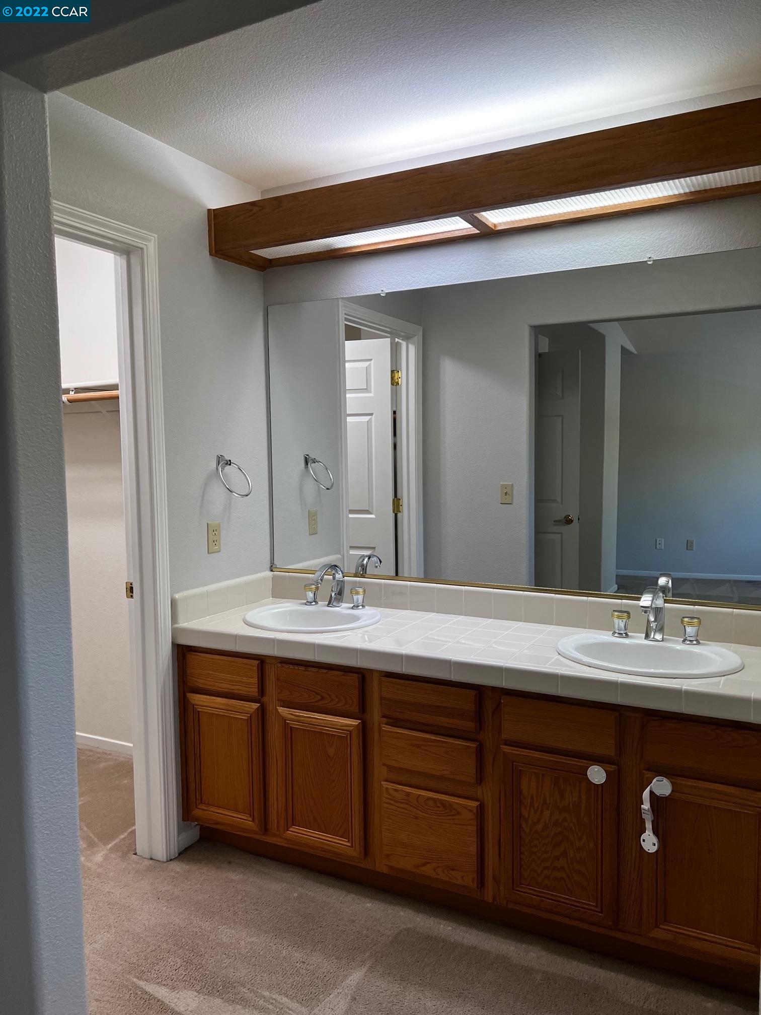 1136 Vista Pointe Circle San Ramon, CA 94583 - Photo 23 of 26 a bathroom with a double vanity sink and a mirror