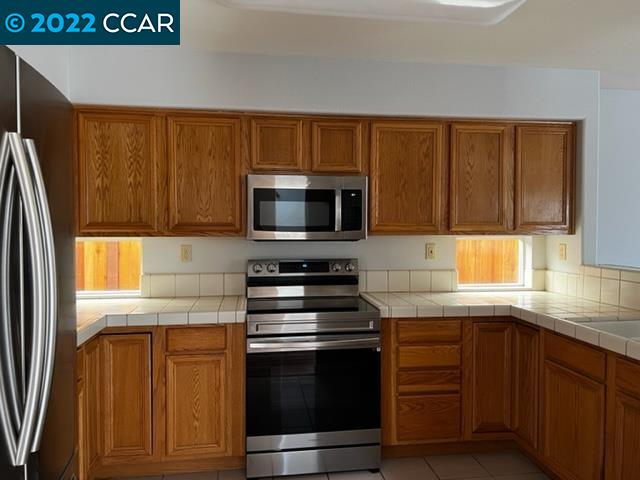 1136 Vista Pointe Circle San Ramon, CA 94583 - Photo 7 of 26 a kitchen with granite countertop stainless steel appliances and wooden cabinets