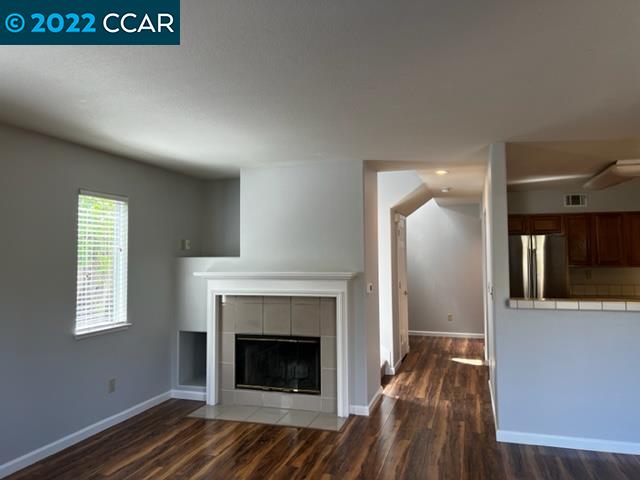 1136 Vista Pointe Circle San Ramon, CA 94583 - Photo 9 of 26 a view of an empty room with wooden floor fireplace and a window