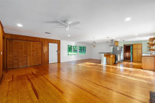 a bathroom with a granite countertop toilet sink and mirror