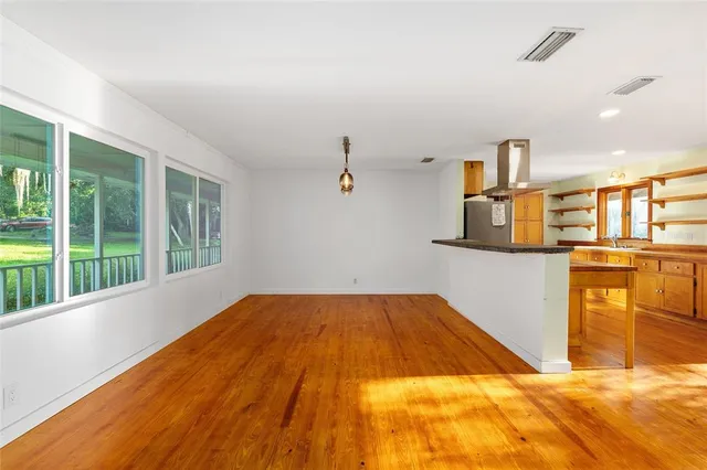 a kitchen with stainless steel appliances granite countertop a sink and a wooden cabinets
