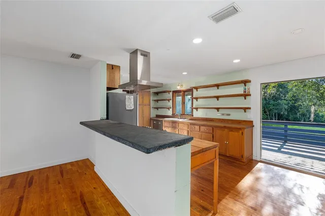 a kitchen with stainless steel appliances granite countertop a sink and a stove