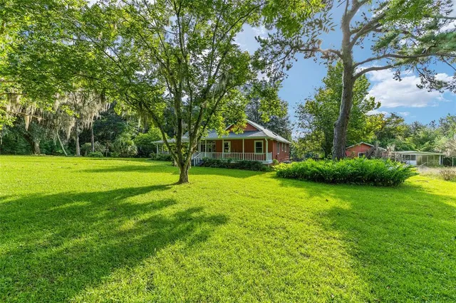 a backyard of a house with yard and outdoor seating