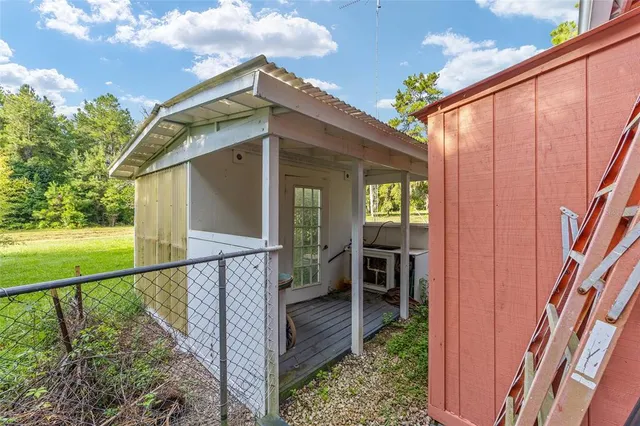 a view of a swimming pool with a yard and palm trees