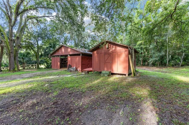 an empty room with wooden floor closet and windows