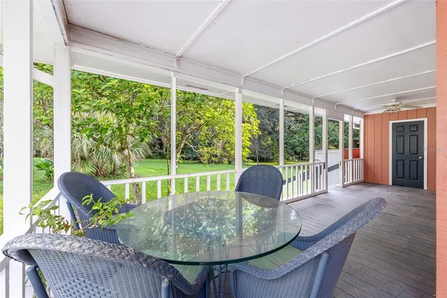 a backyard of a house with yard and outdoor seating