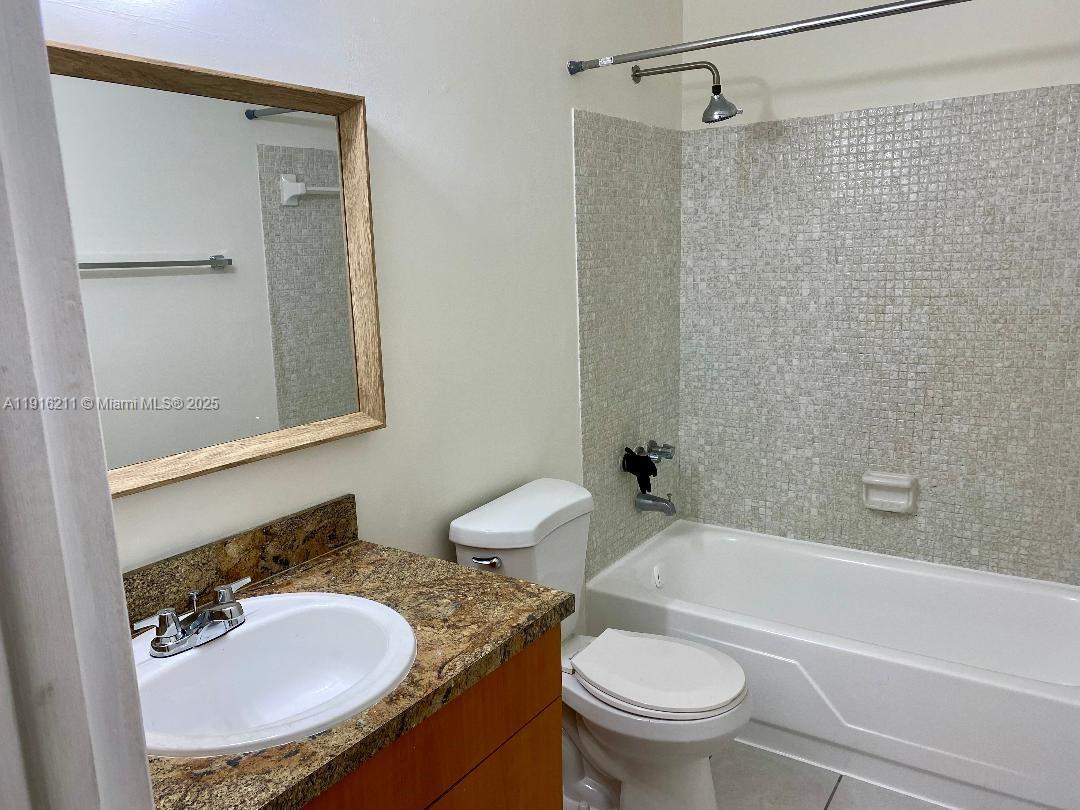11287 Southwest 88th Street, Unit 209L Miami, FL 33173 - Photo 12 of 16 a bathroom with a sink toilet and shower