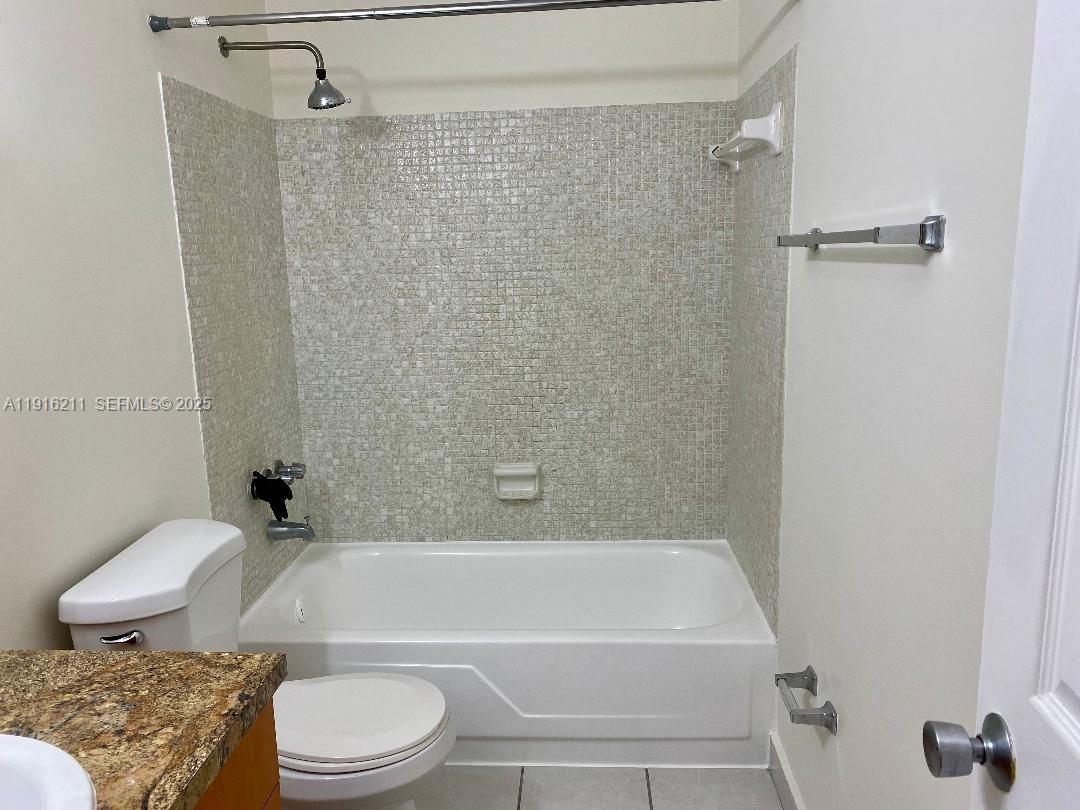 11287 Southwest 88th Street, Unit 209L Miami, FL 33173 - Photo 13 of 16 a bathroom with a toilet and a shower