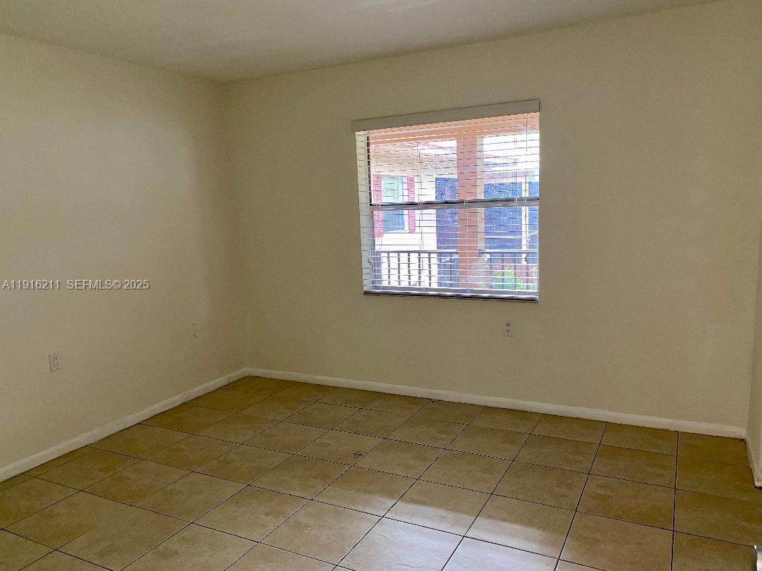 11287 Southwest 88th Street, Unit 209L Miami, FL 33173 - Photo 14 of 16 a view of a room that has a window in it