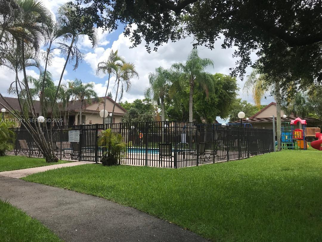 11287 Southwest 88th Street, Unit 209L Miami, FL 33173 - Photo 16 of 16 a view of a park with a tree in the garden