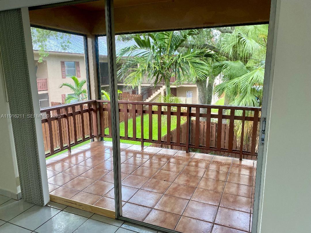 11287 Southwest 88th Street, Unit 209L Miami, FL 33173 - Photo 5 of 16 a view of a balcony with a floor to ceiling window