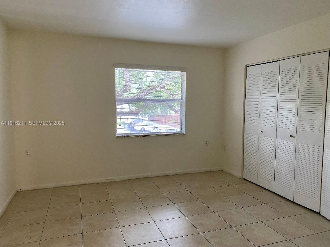 11287 Southwest 88th Street, Unit 209L Miami, FL 33173 - Photo 9 of 16 a view of an empty room with a window