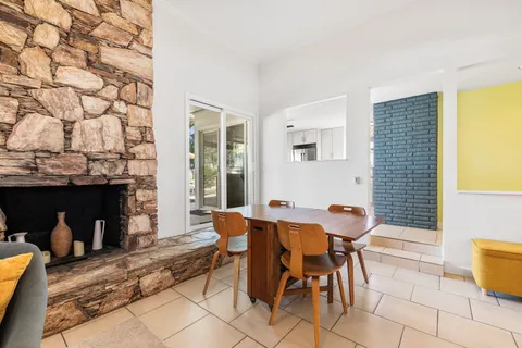 a view of a dining room with furniture and chandelier