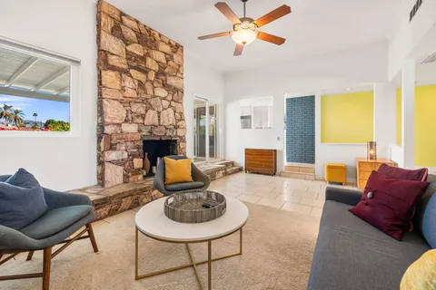 a living room with fireplace furniture and a fireplace