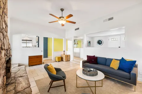 a living room with furniture and a wooden floor