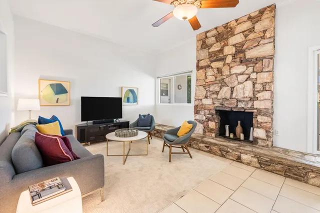 a living room with furniture and a fireplace
