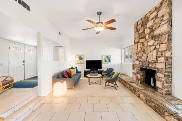 a living room with furniture a fireplace and a flat screen tv