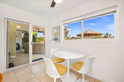 a dining room with furniture and window