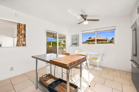 a view of a dining room with furniture and a window