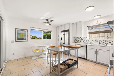 a view of a dining room with furniture and a chandelier