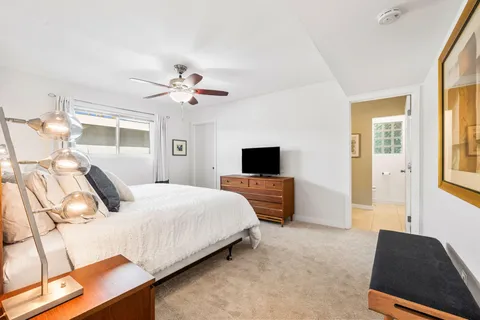 a bedroom with a bed and a television