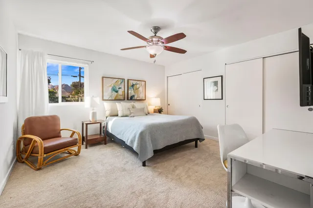 a bedroom with a bed and a couch