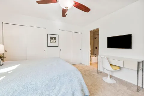 a bedroom with a bed and a flat screen tv