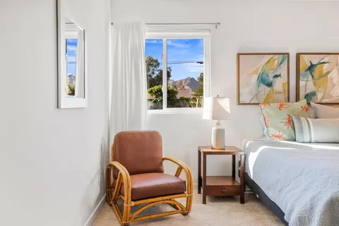 a bedroom with a bed and a painting on the wall