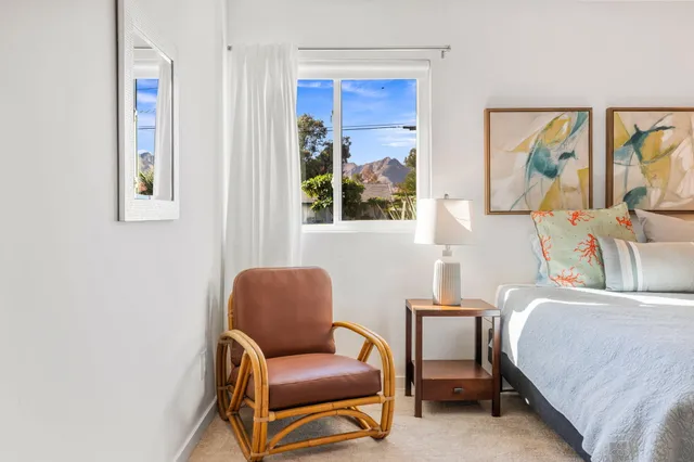a bedroom with a bed and a painting on the wall
