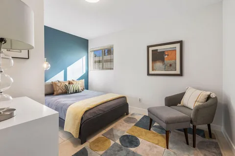 a bedroom with a bed and chair