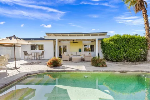 a swimming pool with outdoor seating