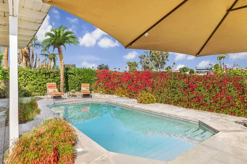 a view of a swimming pool with a yard