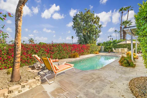 a view of a swimming pool with a lounge chairs